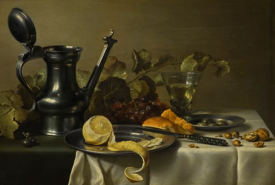 Still life with a 'Jan Steen' jug, a peeled lemon on a pewter plate, bread, olives, grapes, a glass and nuts, Pieter Claesz.